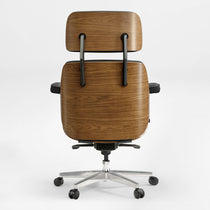 Eureka Ergonomic Mathias executive chair back view with wood veneer shell and black leather seat on a silver five-wheel base.