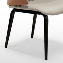 Juliet Dining Armchair Detail: Cream Upholstered Seat, Brown Armrest, Black Legs, Gold Accent, Modern Design.