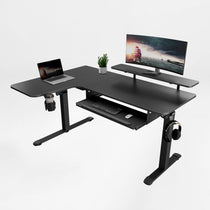 Eureka Ergonomic Black L-shaped standing desk with keyboard tray, monitor riser, laptop, monitor, cup holder, headphone hook.