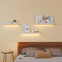 Floating Wall Shelves With Lighting Above a Bed, Modern Bedroom Decor With Art and Accessories, Eureka Ergonomic.