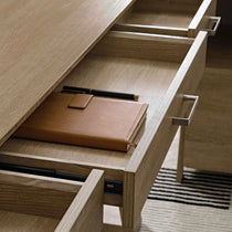 Eureka Ergonomic Ark El Executive Standing Desk Drawer Detail With a Leather Notebook and Pen Inside, Oak Veneer Finish.