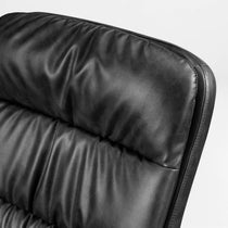 Eureka Ergonomic Black PU leather close-up on Regal office chair showing tufted cushioning and stitching for material quality.