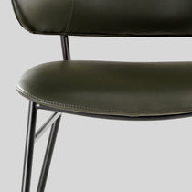 Green Finn Dining Chair Detail With Black Steel Frame, Modern Industrial Design.