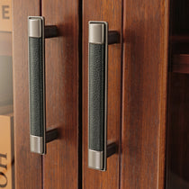Eureka Ergonomic 72 Walnut Bookcase Detail, Black Leather Door Handles, Walnut Wood Grain.