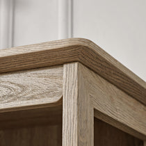 Eureka Ergonomic Ark El Oak Bookshelf Corner Detail, Showcasing Wood Grain and Craftsmanship.