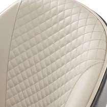 Anareli Dining Chair Detail: Beige Diamond-Stitched Faux Leather Backrest With Silver Stitching and Dark Brown Trim.