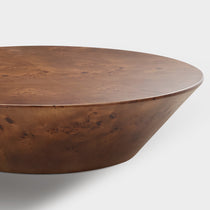 Brown Round Coffee Table With Wooden Veneer Surface, a Stylish Addition to Living Space.