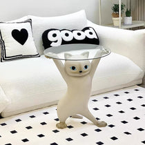 Enchanting Beige Cat Side Table With Clear Glass Tray, Holding a Stylish Home Decor, With 'Good' Pillow.