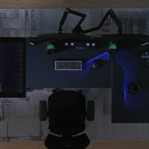 Eureka Ergonomic GTG L-shaped desk with dual monitors, keyboard, mouse, and RGB wave lighting.