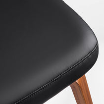 Eureka Ergonomic Belmar black leather dining chair seat detail with wood frame and stitching.