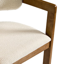 Eureka Ergonomic Close-up of ivory boucle fabric texture on Elle dining chair with walnut wood frame.