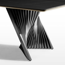 Eureka Ergonomic Oasis 105.5" black sintered stone dining table, detailed view of twisted metal base and subtle white veining on top.