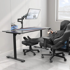 Ergonomic Gaming Setup With Black Chair, Footrest, and Desk for Comfortable Posture, Perfect for Long Gaming Sessions.