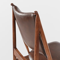 Mid-Century Modern Brown Leather Dining Chair Detail With Ash Wood Frame.