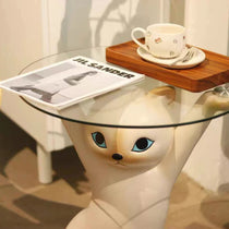 Enchanting Cat Side Table With Beige Cat Base, Clear Glass Tray, Holding Jil Sander Magazine, Stylish Home Decor.