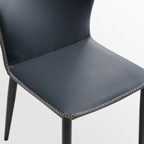 Elysian Blue Dining Chair Detail: Dark Blue Pu Leather With White Stitching and Black Metal Legs.