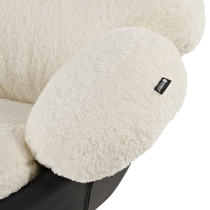 Cara Swivel Lounge Chair Detail: White Lamb Velvet Upholstery, Black Leather Base, Eureka Ergonomic Tag.
