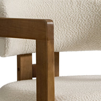 Eureka Ergonomic Close-up of Elle dining chair armrest showcasing ivory boucle fabric texture and walnut wood detail.