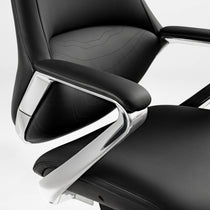 Eureka Ergonomic Nox black leather executive chair close-up: textured material, stitching, chrome accents.