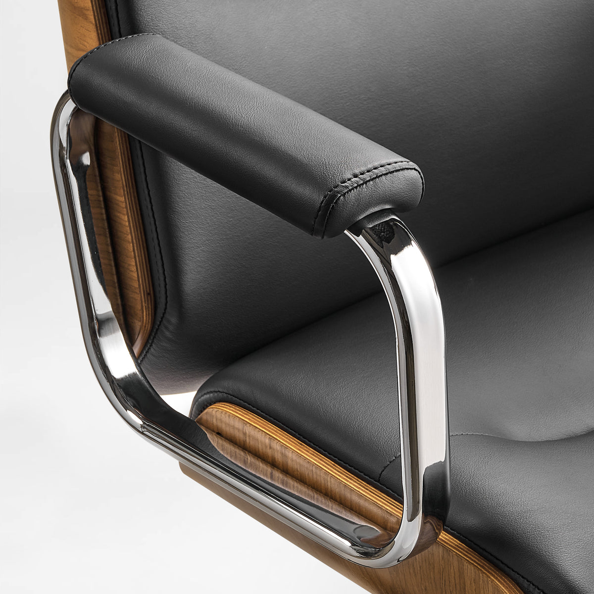 Eureka Ergonomic close-up of the black Mathias Mason chair's chrome armrest and padded arm support 