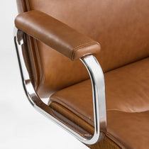 Eureka Ergonomic close-up of the brown Mathias Mason chair's chrome armrest and padded arm support