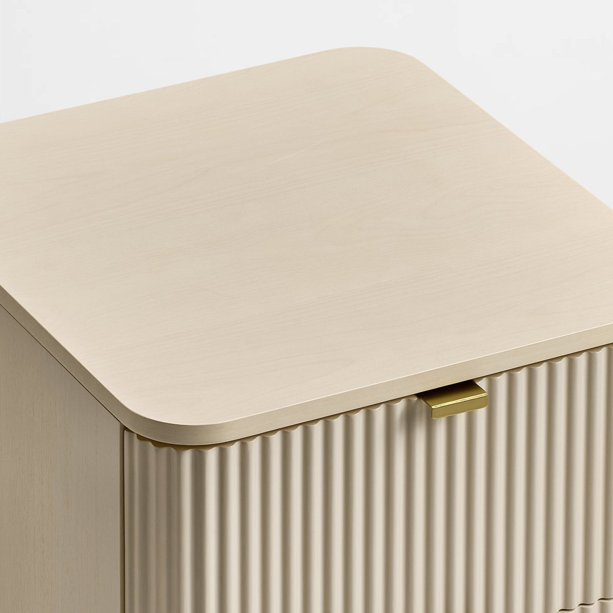 Eureka Ergonomic Opal file cabinet detail of the rounded top corner and fluted front beside a brass pull