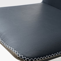Close-Up of Elysian Blue Dining Chair's Seat Detail. Dark Blue Pu Leather With White Stitching.