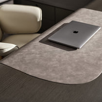 Eureka Ergonomic Zen Orion executive desk close-up: light gray textured surface, dark wood grain base, and silver laptop.