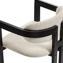 Eureka Ergonomic Close-up of ivory boucle fabric texture on Elle dining chair armrest with black wood frame.