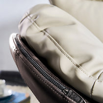 Alexia Comfy Swivel Lounge Chair Detail, Showing Cream Vegan Leather and Brown Zipper Detail, Ergonomic Design.