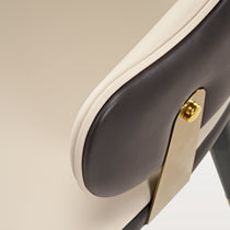 Anareli Dining Chair Detail, Beige and Dark Brown Faux Leather, Golden Accents.