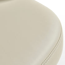 Acalay Beige Dining Armchair Detail, Showcasing Faux Leather Upholstery and Stitching.