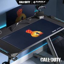 Call of Duty Eureka Ergonomic Mousepad, Featuring a Character Silhouette and Sunset Design On a Gaming Desk Setup.