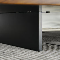 Modern Square Solid Wood Coffee Table Detail With Black Metal Frame and Wood Grain Texture On a Light Rug.