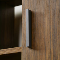 Close-Up of Napa Wood Bookcase Cabinet Detail Showing Metal Handle and Wood Grain Texture.