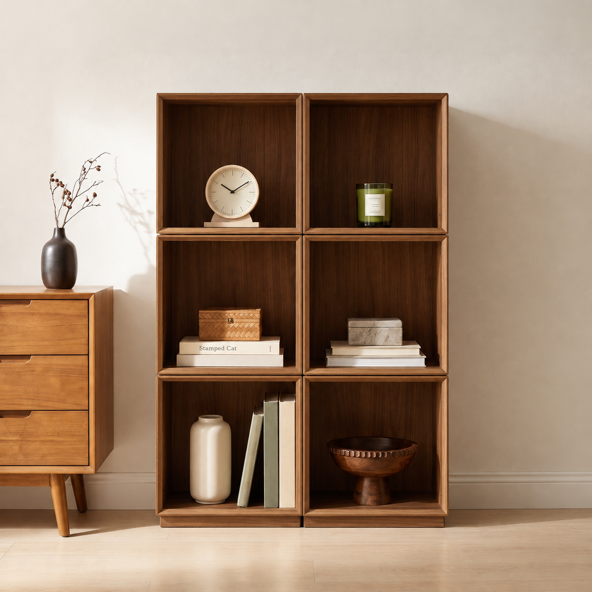 Eureka Ergonomic Cubo walnut rotating storage cubes — two units placed side by side against the wall, styled with a clock, candle, and vases.