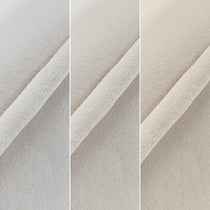 Close-Up of Off-White Velvet Fabric On Shanean Dining Chair, Soft Texture and Material Detail.