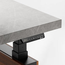 Zen Pro Standing Desk, Grey Sintered Stone Desktop, Control Panel, and Wood Grain Accents By Eureka Ergonomic.