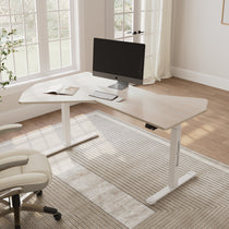 Eureka Ergonomic Blossom Dynamics light wood grain L-shaped standing desk with white frame, monitor, keyboard, mouse in bright home office.