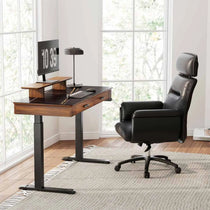 Eureka Ergonomic George Slate Standing Desk, Modern Home Office Setup With Black Leather Chair and Monitor Showing 10: 39 Time.