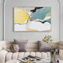 Abstract Wall Art Print With Yellow, Blue, and Black Shapes, Framed Above a Sofa.