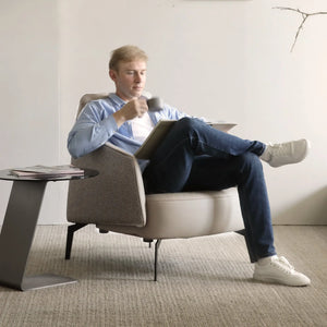 Ivory Napa Leather Lounge Chair With Man Relaxing, Ergonomic Design for Living Room.