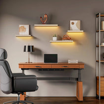 Eureka Ergonomic Modern Home Office Setup With Floating Shelves, Adjustable Desk, and Ergonomic Chair, Featuring Decor.