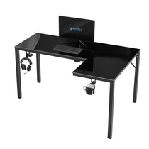 Eureka Ergonomic GTG L-shaped glass gaming desk with monitor, keyboard, headphone hook, and cup holder.