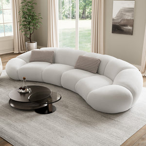 Modern Curved Sofa in a Bright Living Room Setting, Soft White Fabric, and Stylish Design.