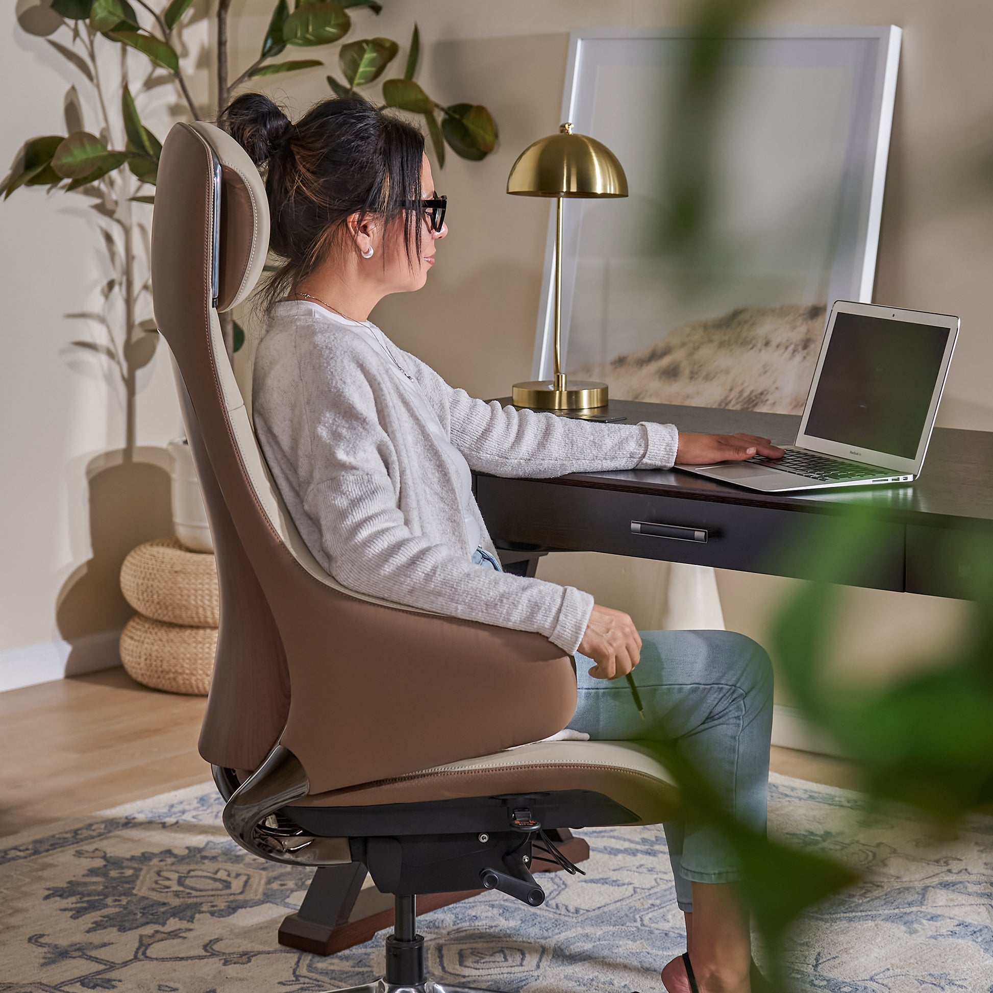 Woman sitting at a desk with a laptop in a home Serene Ella  Executive office  chair