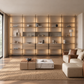 Eureka Ergonomic Arundel shelving system as a backlit full-wall bookshelf in a warm minimalist living room